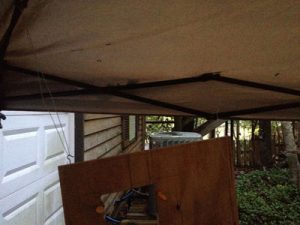 Hanging the plywood under the tent allows me to get to all surfaces for a quick paint job, rain or shine.